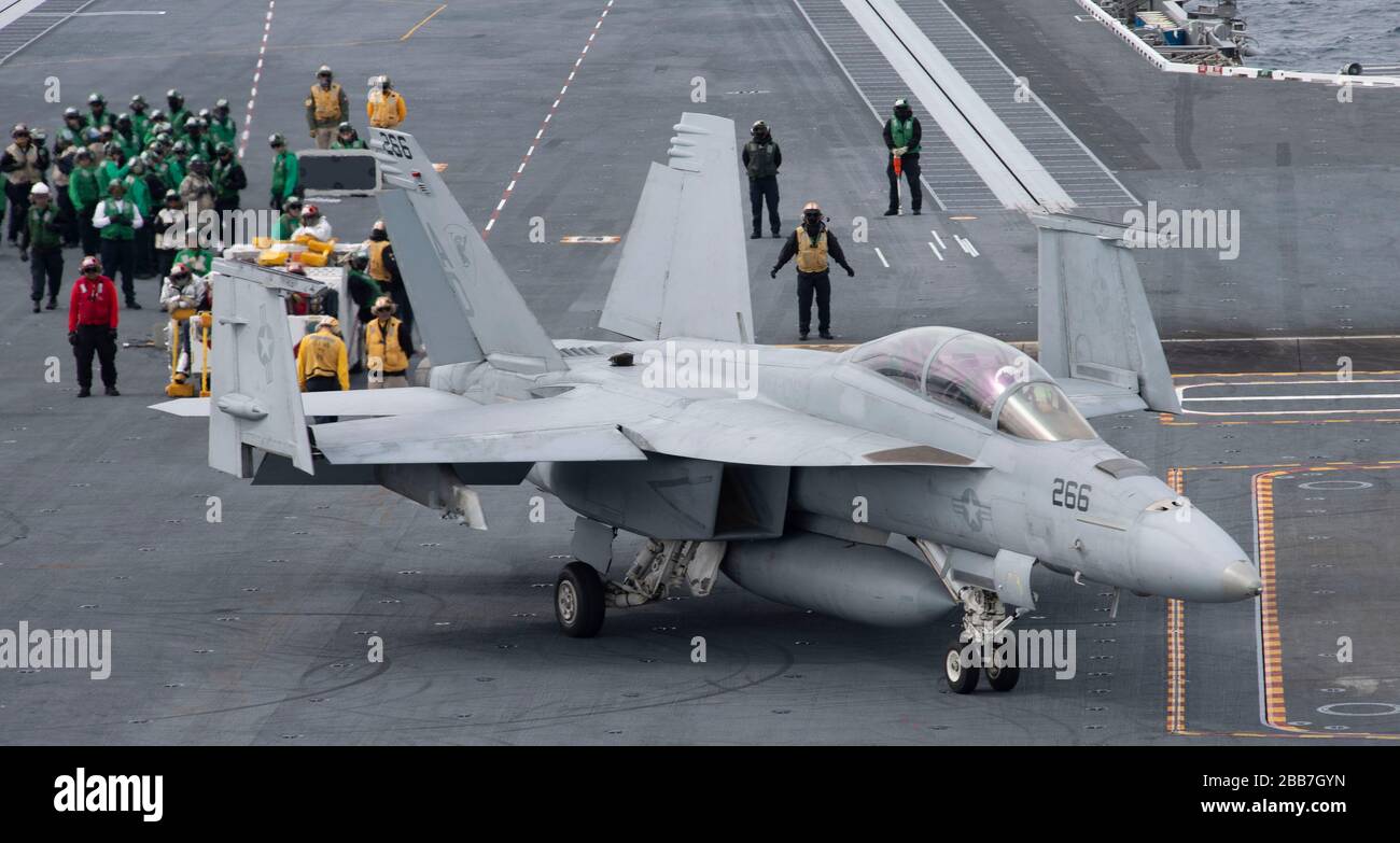 A U.S. Navy F/A-18F Super Hornet, attached to the 'Gladiators' of Strike Fighter Squadron 106, taxis on the flight deck of Nimitz-class aircraft carrier USS Gerald R. Ford during flight operations March 27, 2020 underway in the Atlantic Ocean. Stock Photo