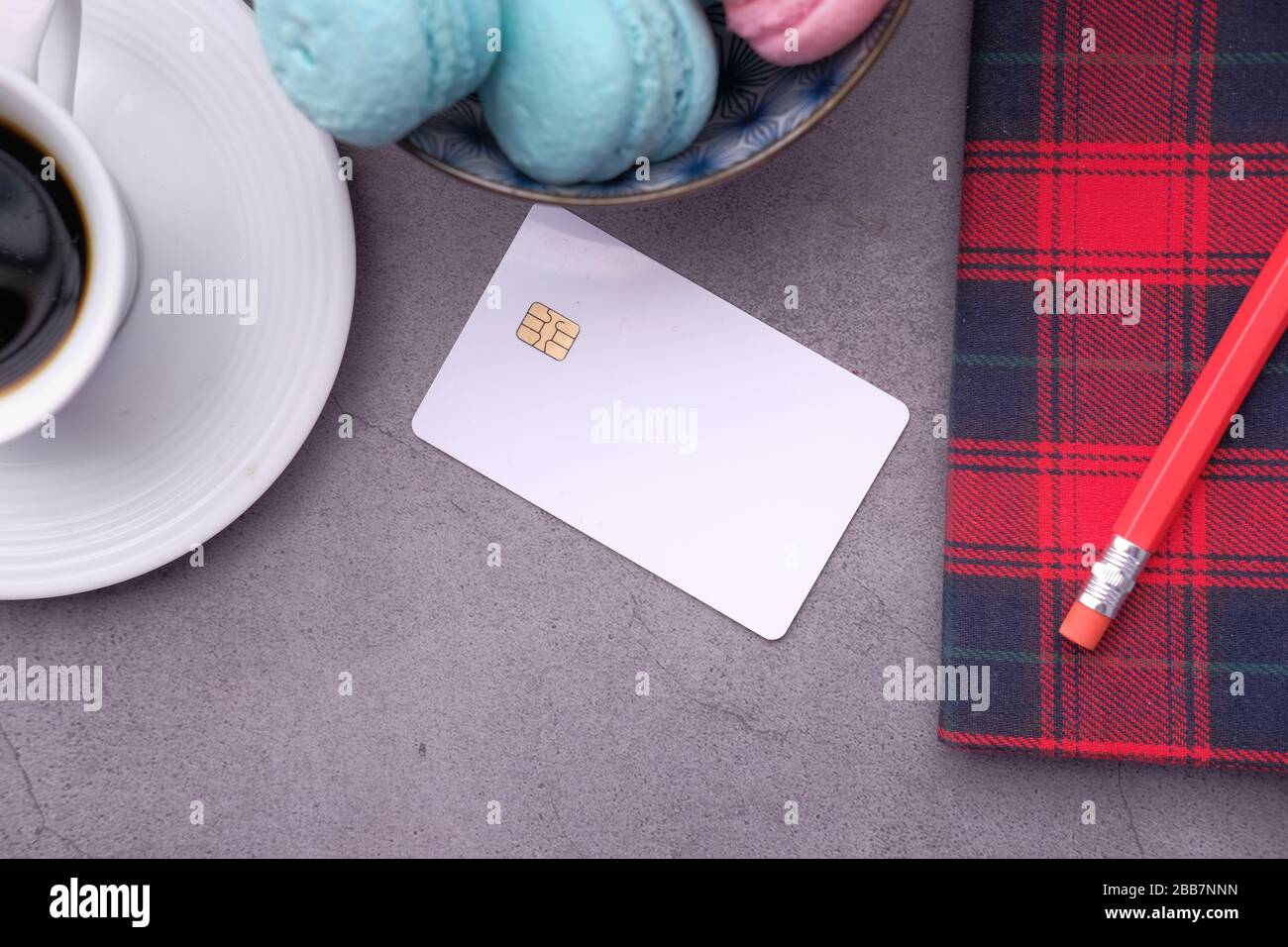 credit card with tea and notepad on table Stock Photo