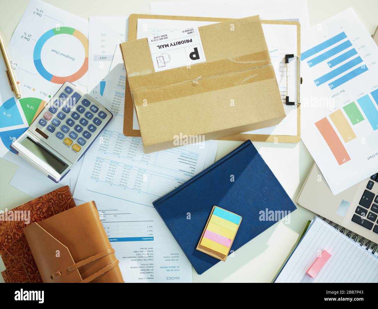 Upper view of parcel on the desk with documents at the table. Stock Photo