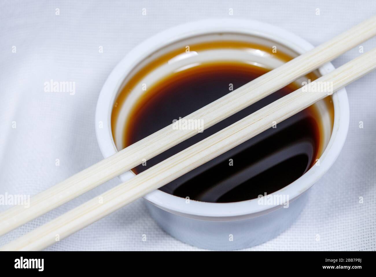 soy sauce in a disposable bowl on a white background Stock Photo Alamy