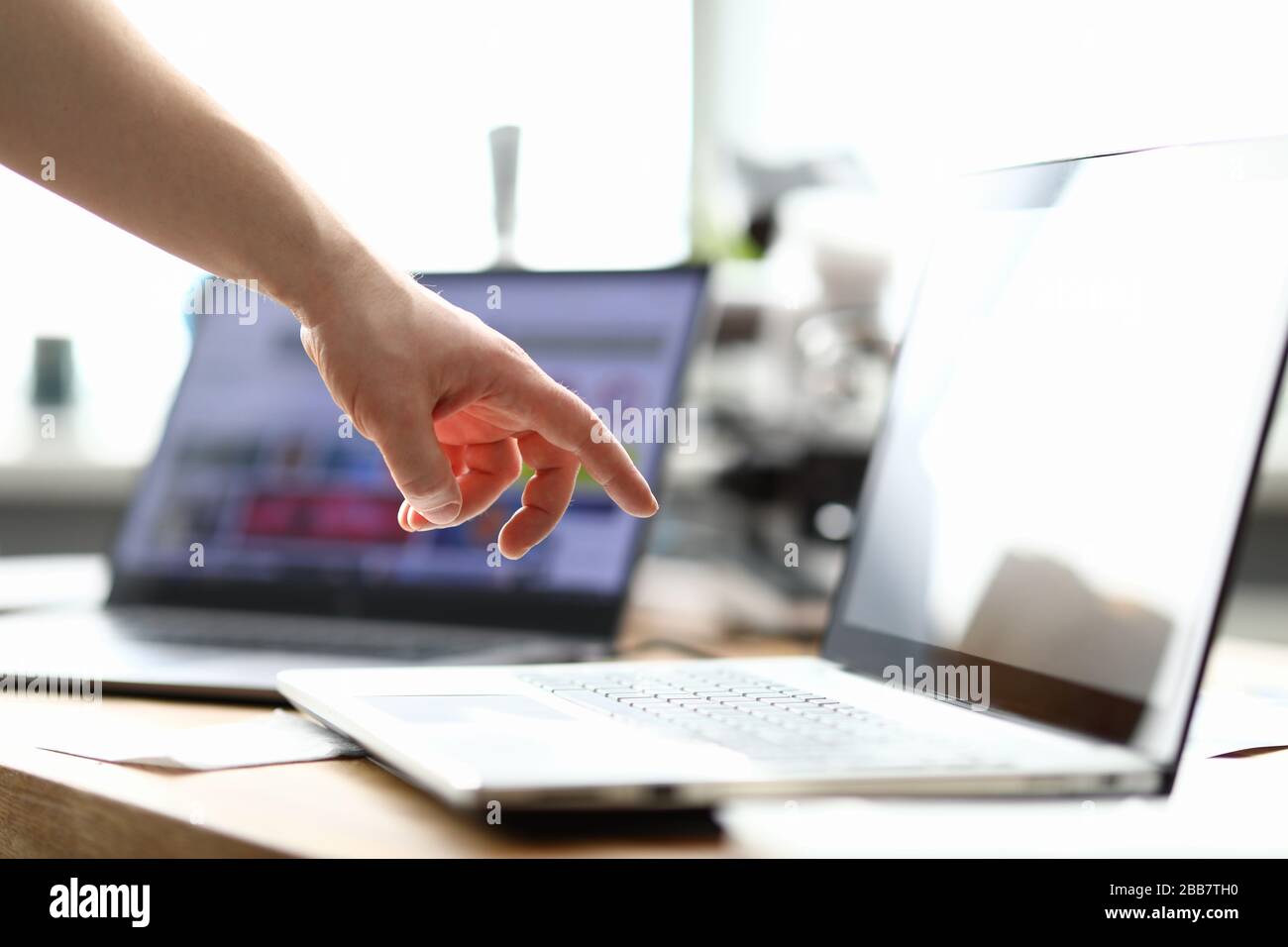 Hand reaches laptop hi-res stock photography and images - Alamy