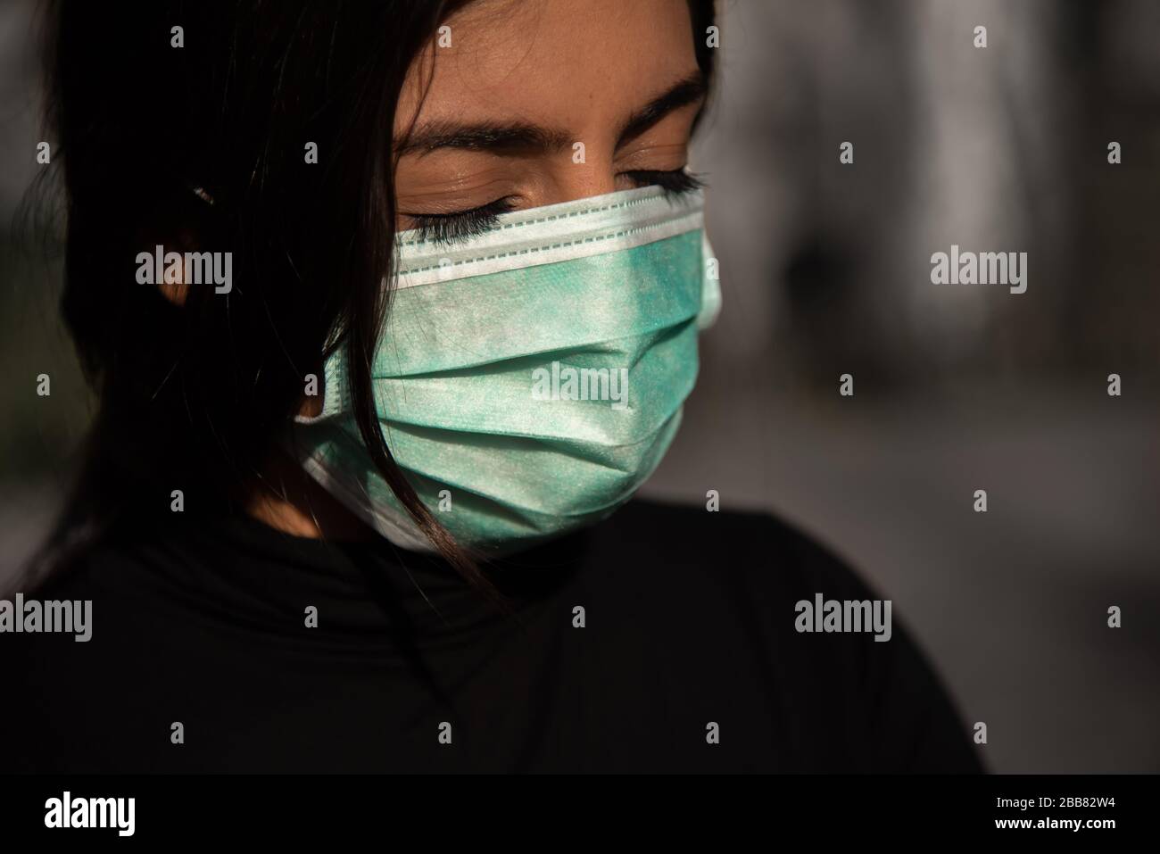 tired woman with protective fase mask - covid-19 corona crisis concept picture Stock Photo