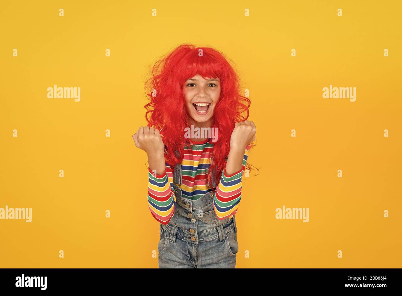 I am ginger and proud of it. Redhead stereotypes. Redheads are not some creatures with magical soul sucking powers. Crazy redhead wig. Messy hairstyle. Kid cheerful smiling happy redhead girl. Stock Photo