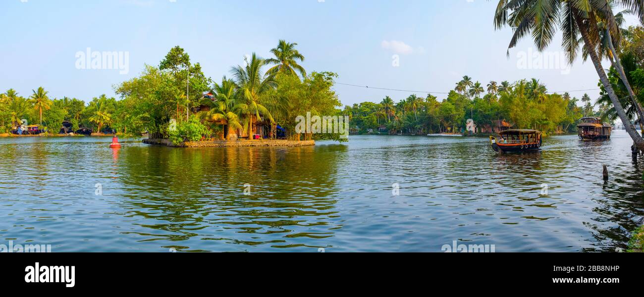 Alleppey, Kerala, India - March 30, 2018: Panoramic view of a backwaters canal with two boats Taken in the morning. Stock Photo