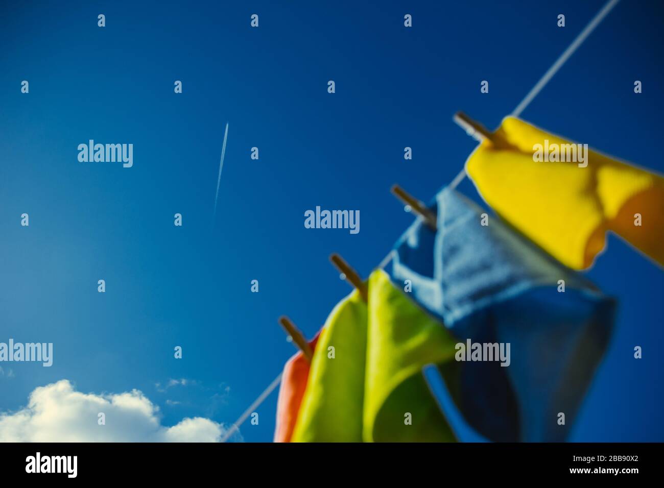 Blue skies with colourful laundry hanging Stock Photo