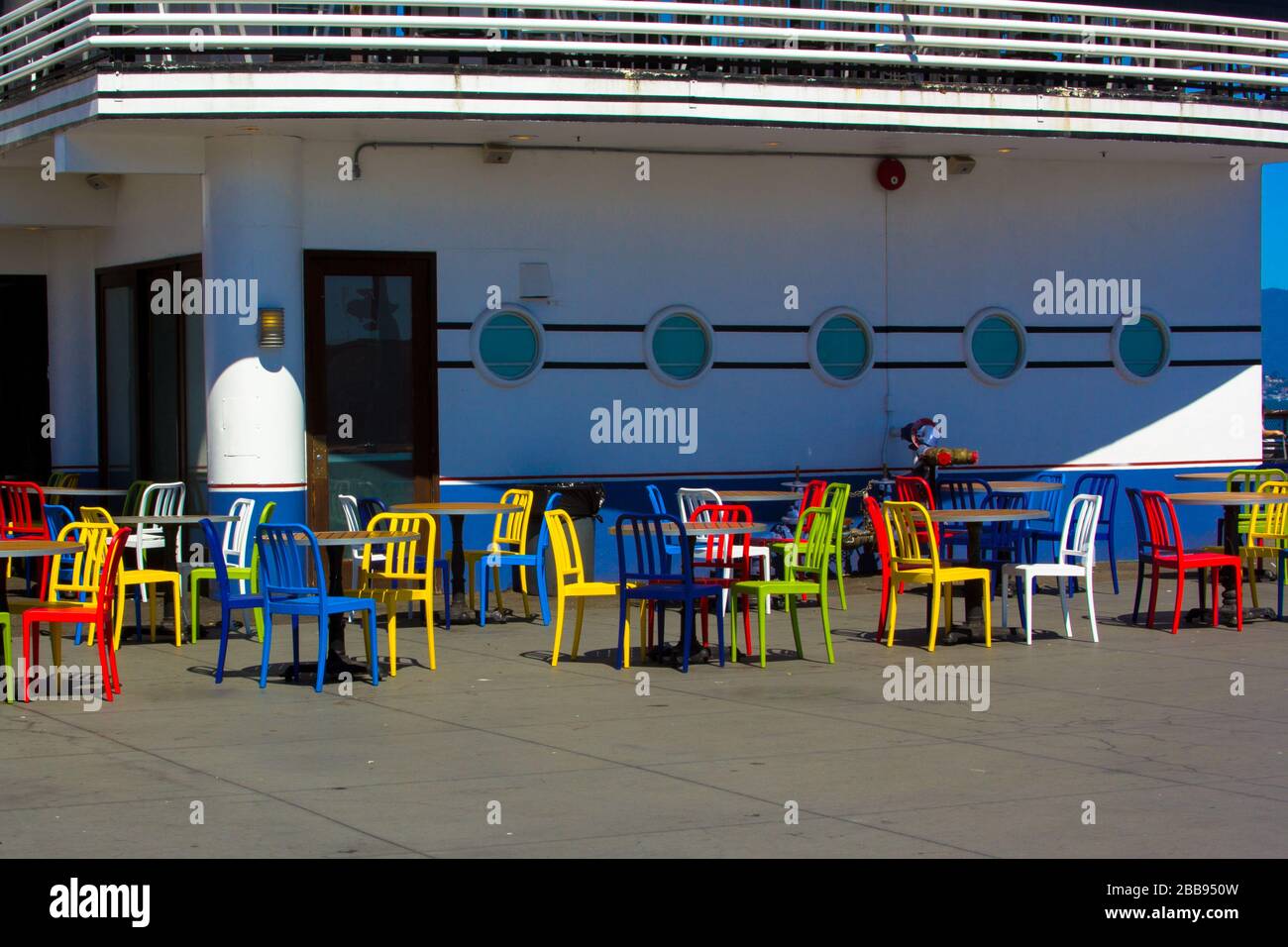 Colorful empty chairs ready for outside diners Stock Photo