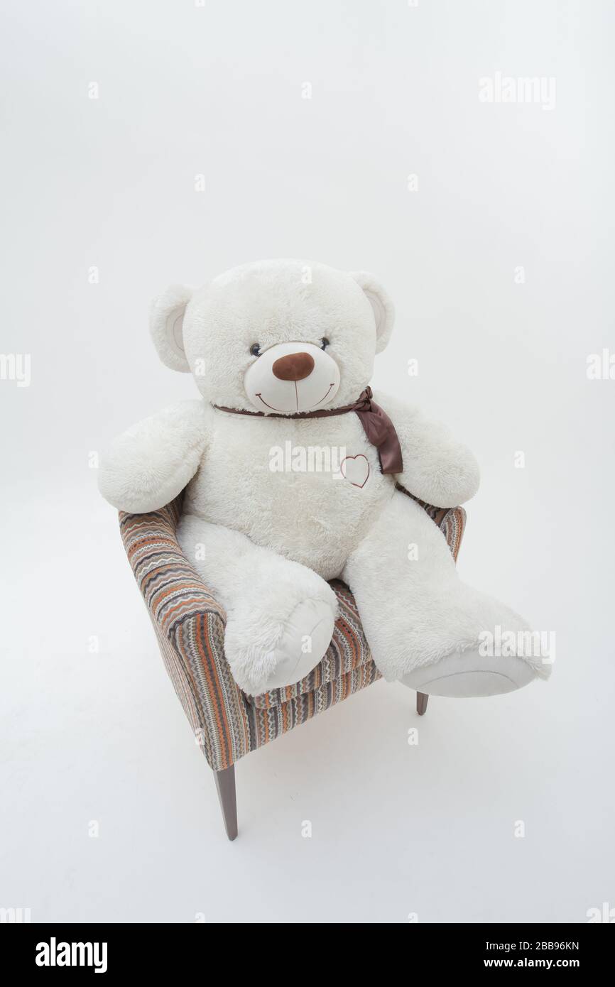 White teddy bear in chair. Isolated on white background Stock Photo - Alamy