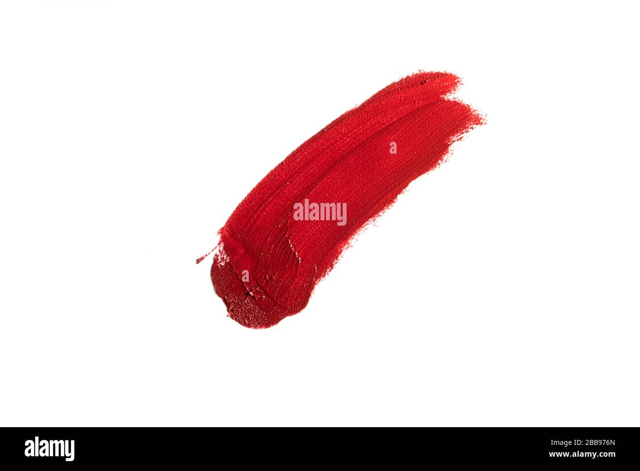 Red lipstick cosmetic product brush stroke swipe sample. Lipstick swatch smudge smear isolated on white background. Cream makeup texture. Stock Photo