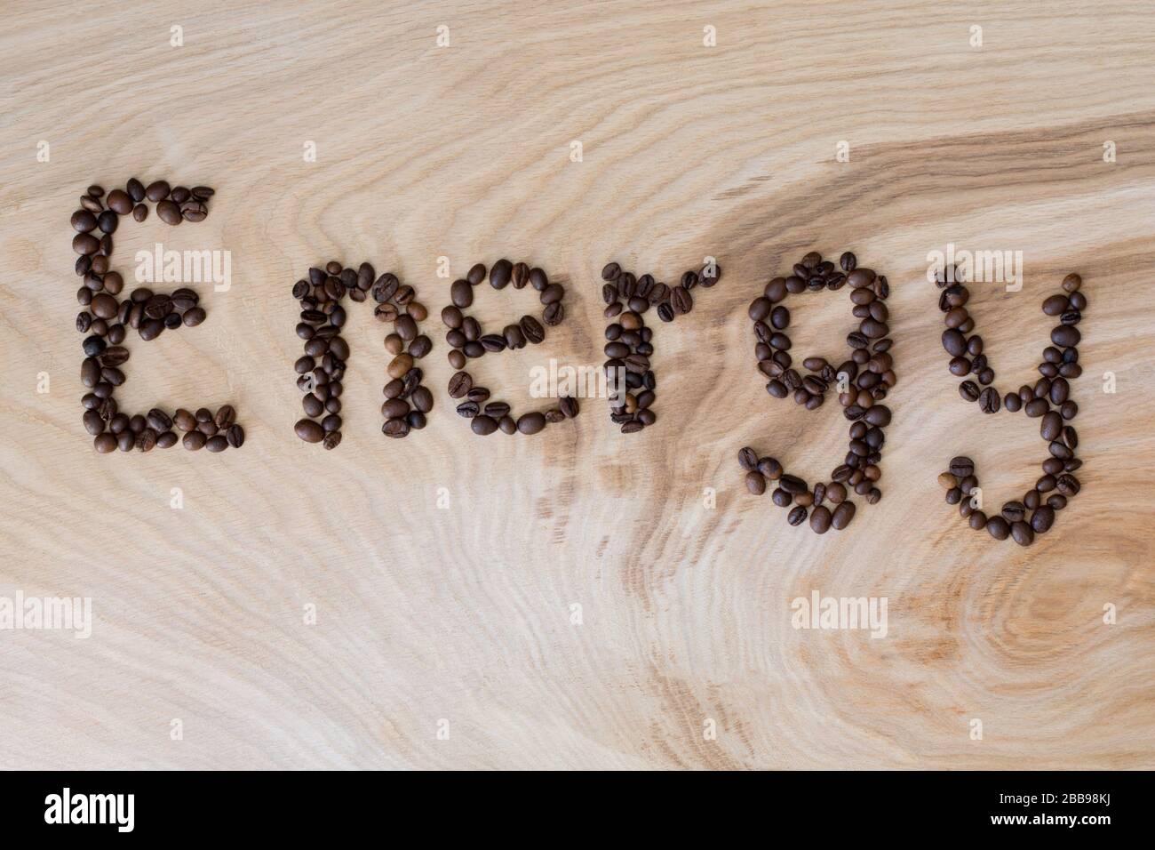 Word energy laid out from coffee grains on wooden background Stock Photo