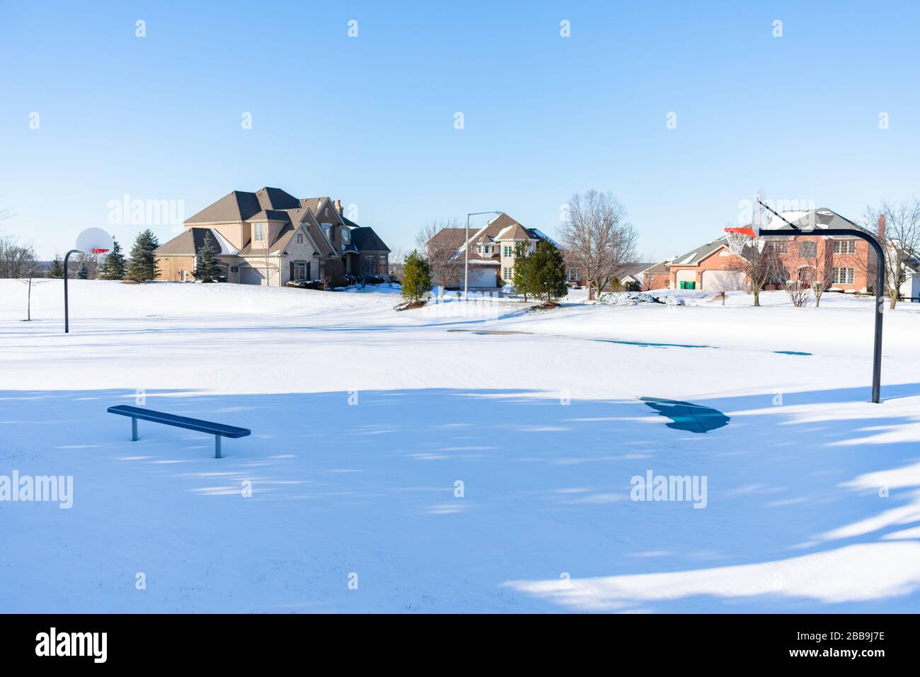 Snow Covered Basketball Court in a Midwest Suburb Stock Photo