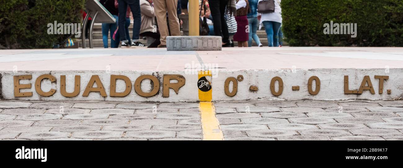 QUITO, ECUADOR - JULY 29, 2018: A yellow line painted on the ground showing the zero degree latitude and longitude coordinates. Stock Photo