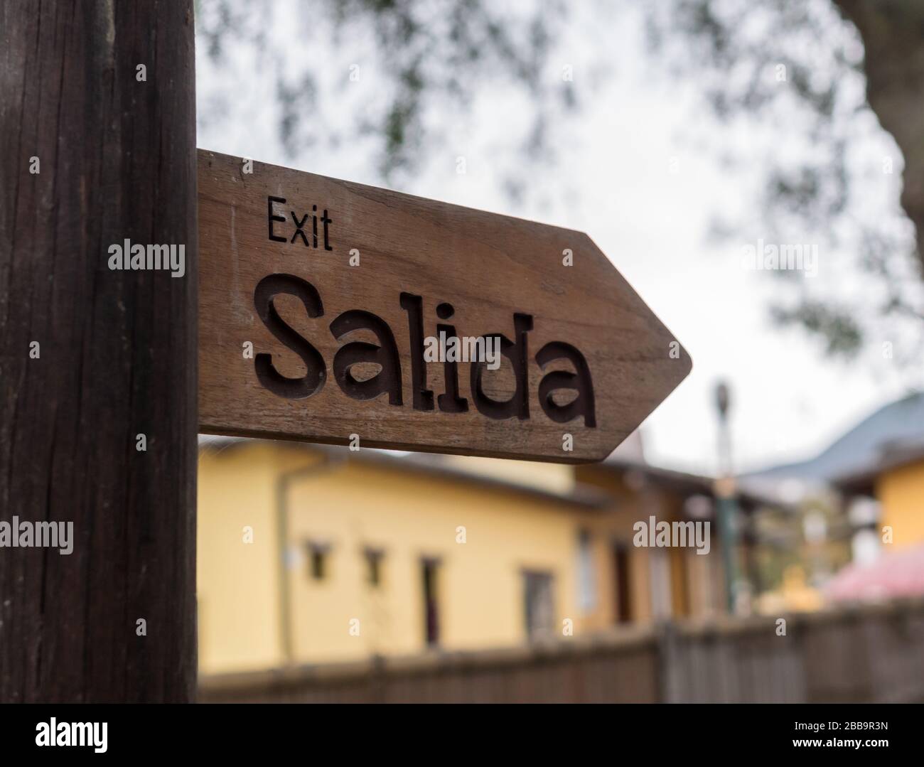 A wooden exit sign written in Spanish Stock Photo Alamy