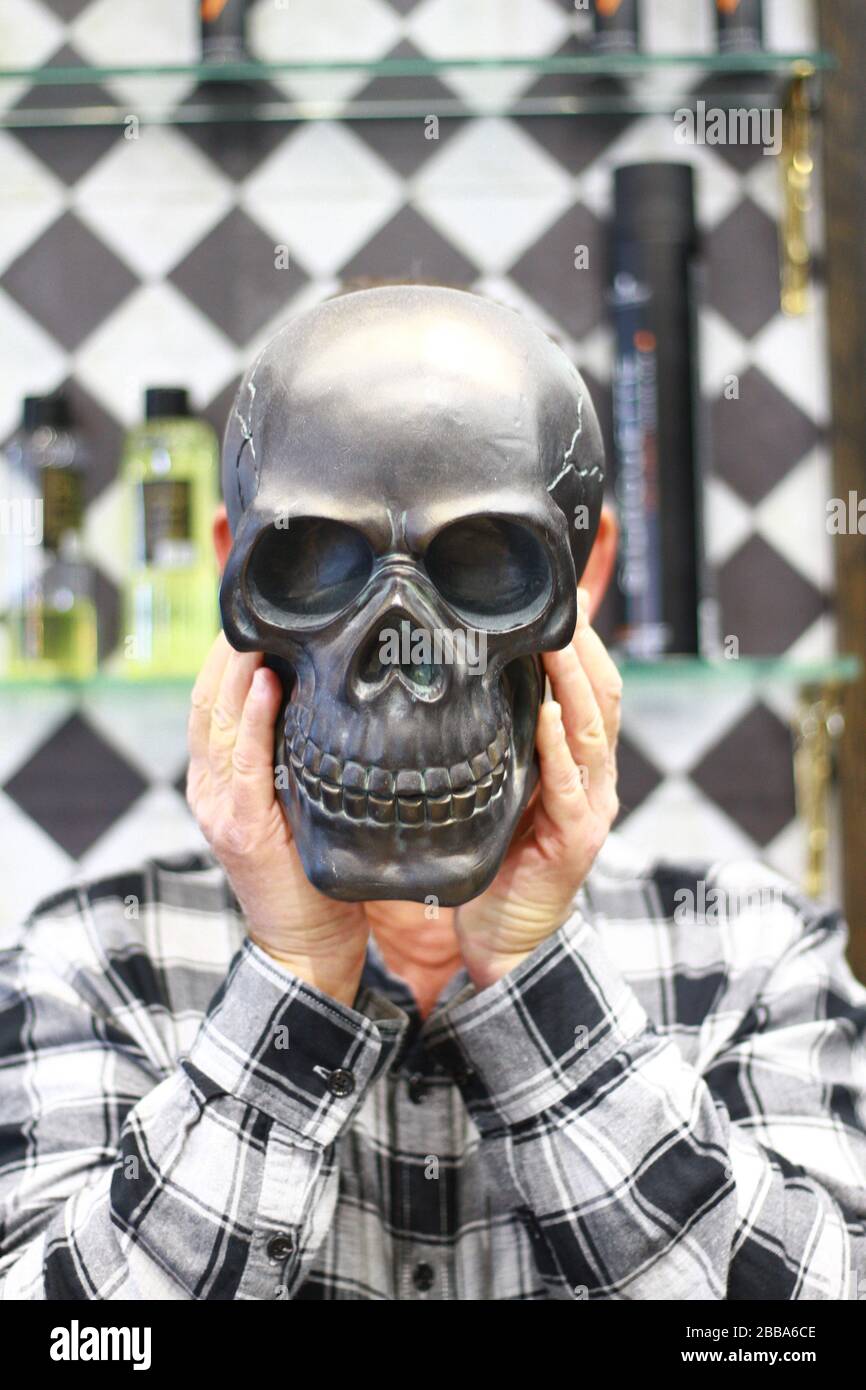STAY HOME. PROTECT THE NHS. SAVE LIVES. ONLY GO OUT IF IT IS ABSOLOTELY ESSENTIAL DURING LOCKDOWN. WE ALL HAVE TO TAKE RESPONSIBILITY TO ABIDE BY GOVERNMENT GUIDE LINES. LIVES ARE IN OUR HANDS. HUMAN SKULL MODEL. Stock Photo