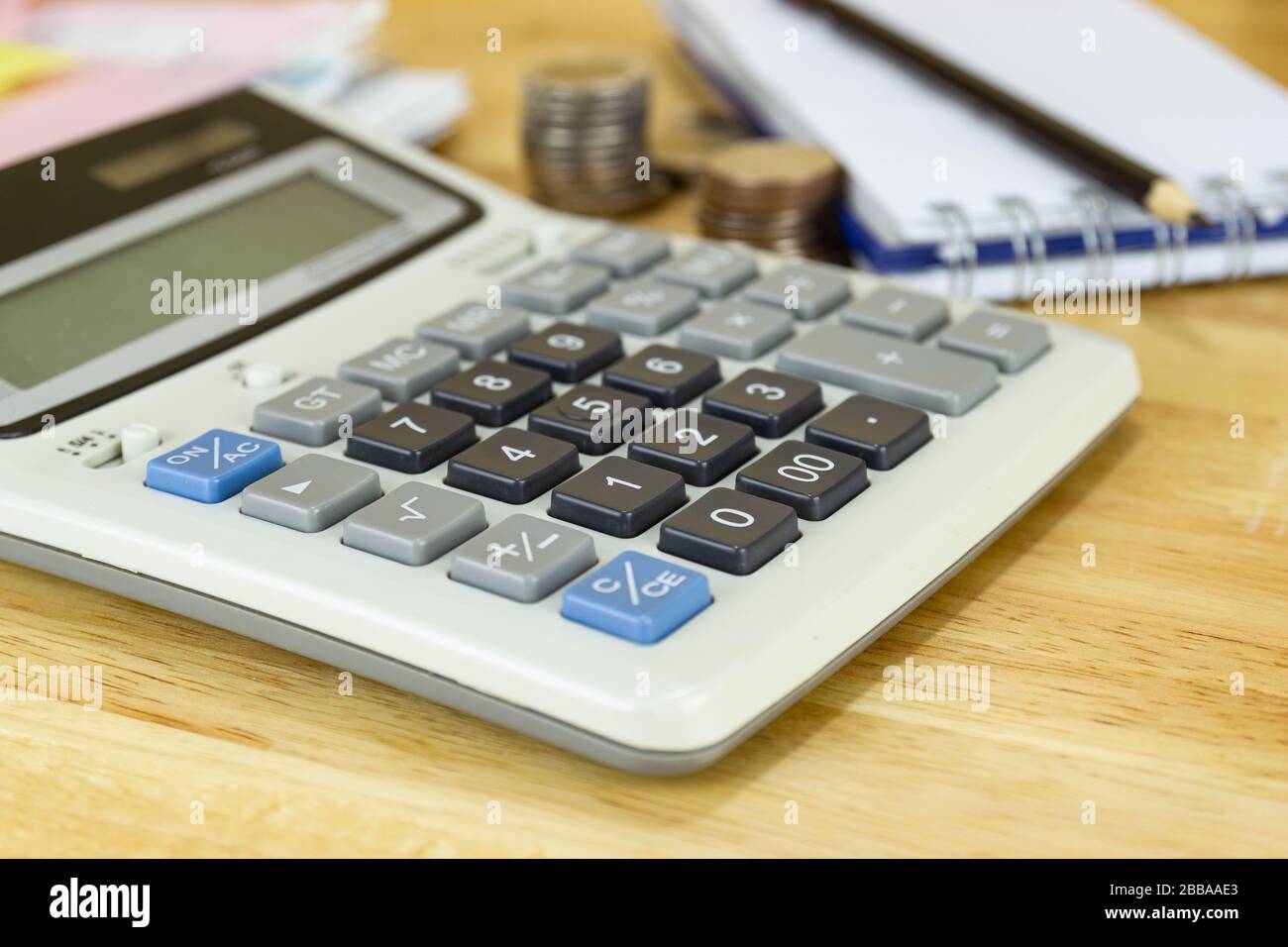 calculator on wood table at office, concept of calculating expenses, incomes and expenses. Stock Photo