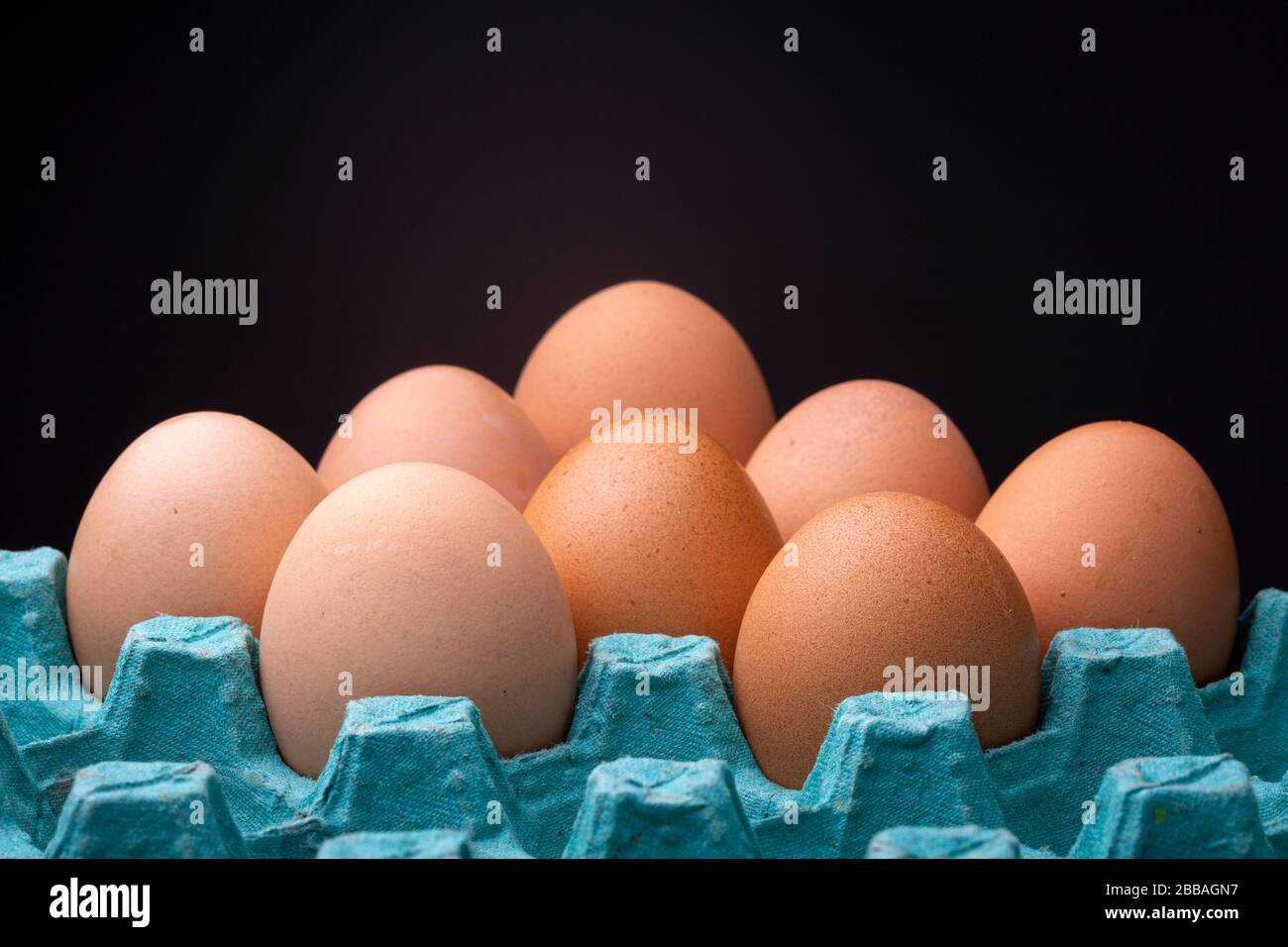 Happy brown shaded chicken eggs in colourful teal egg carton box