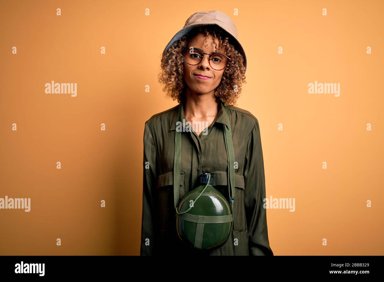 Young african american tourist woman on vacation wearing explorer hat ...