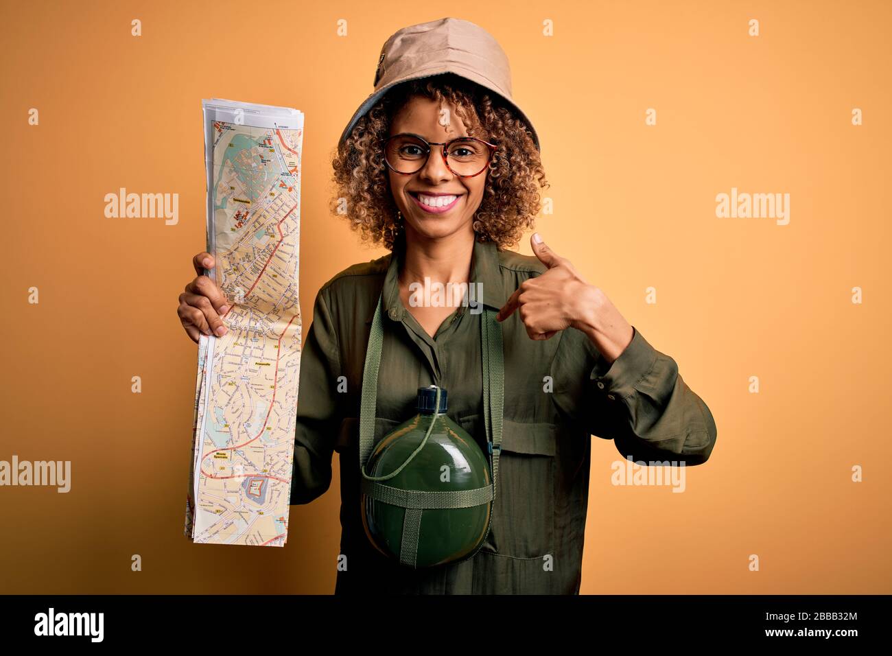 African american tourist woman wearing explorer hat and water canteen ...