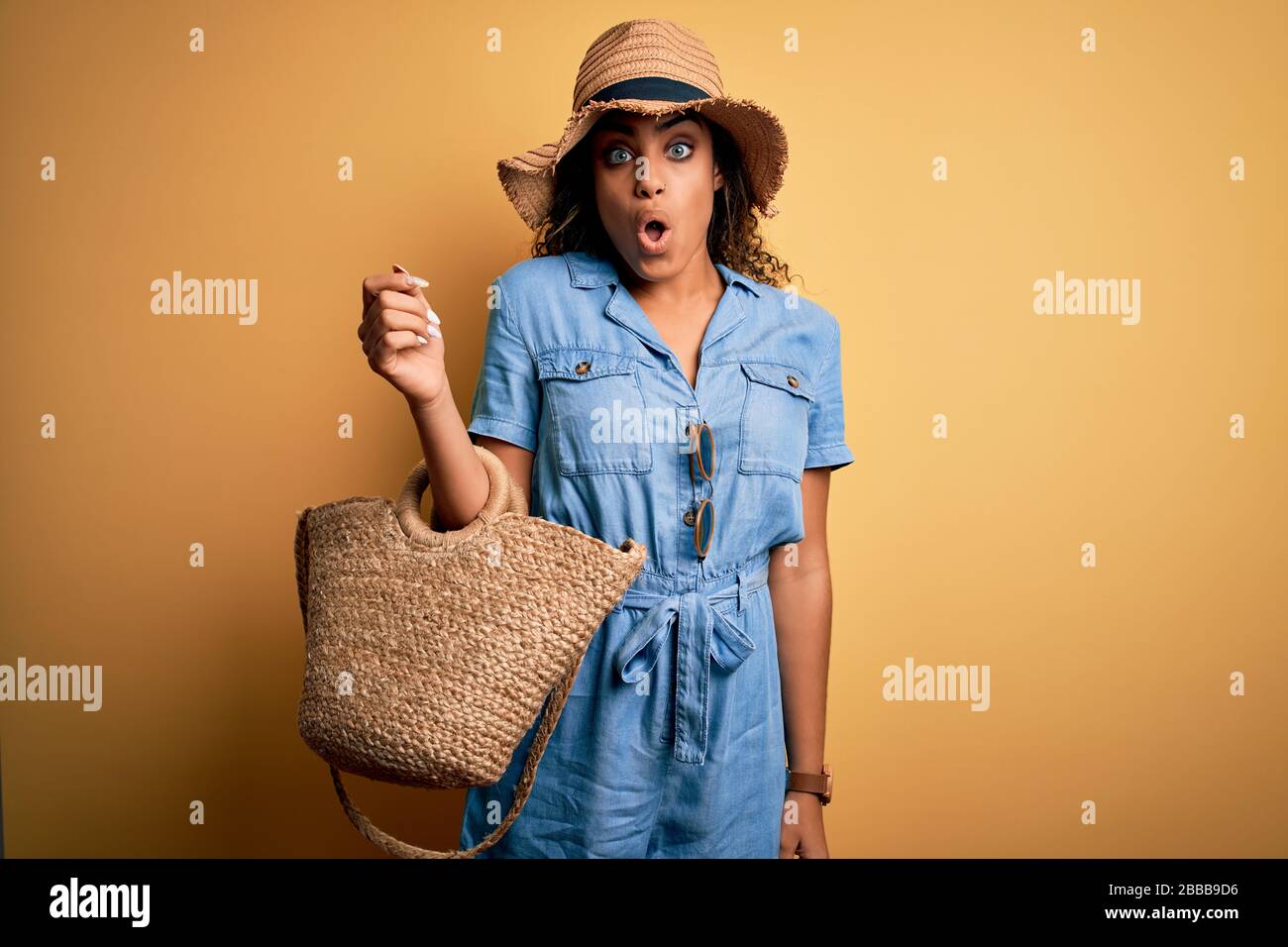 Young african american tourist girl on vacation wearing summer hat and ...