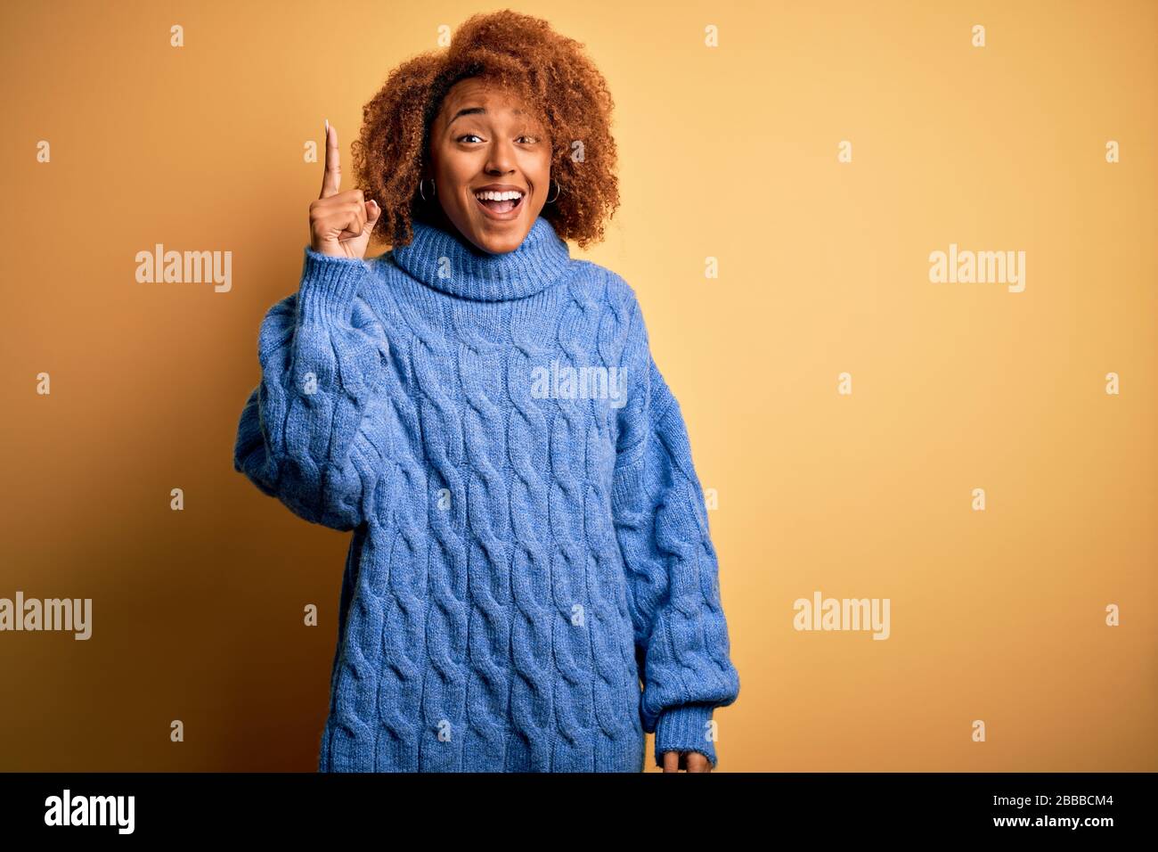 Young beautiful African American afro woman with curly hair wearing ...