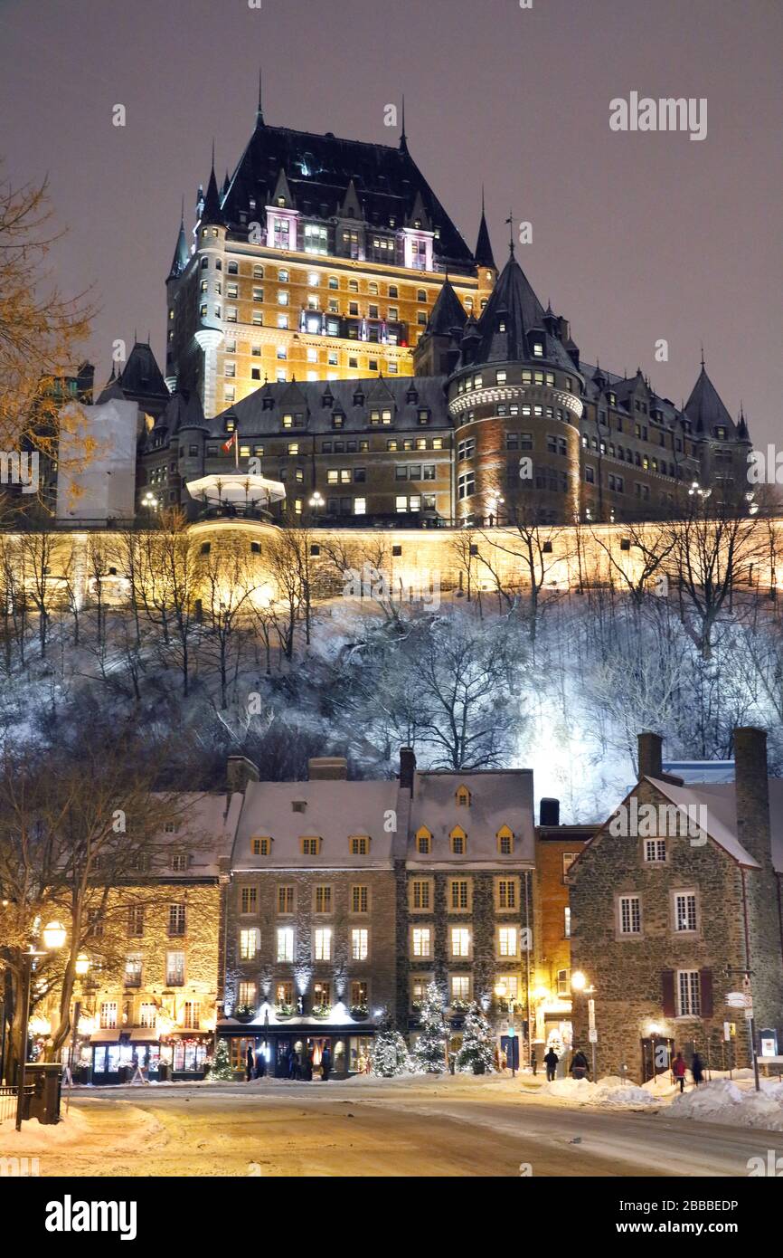 Nighttime scene encompassing the Upper Town of Old Quebec City which prominently features the Chateau Frontenac and the Lower Town exemplified by the row of colonial-style buildings on Champlain Boulevard. Quebec City, Quebec, Canada Stock Photo