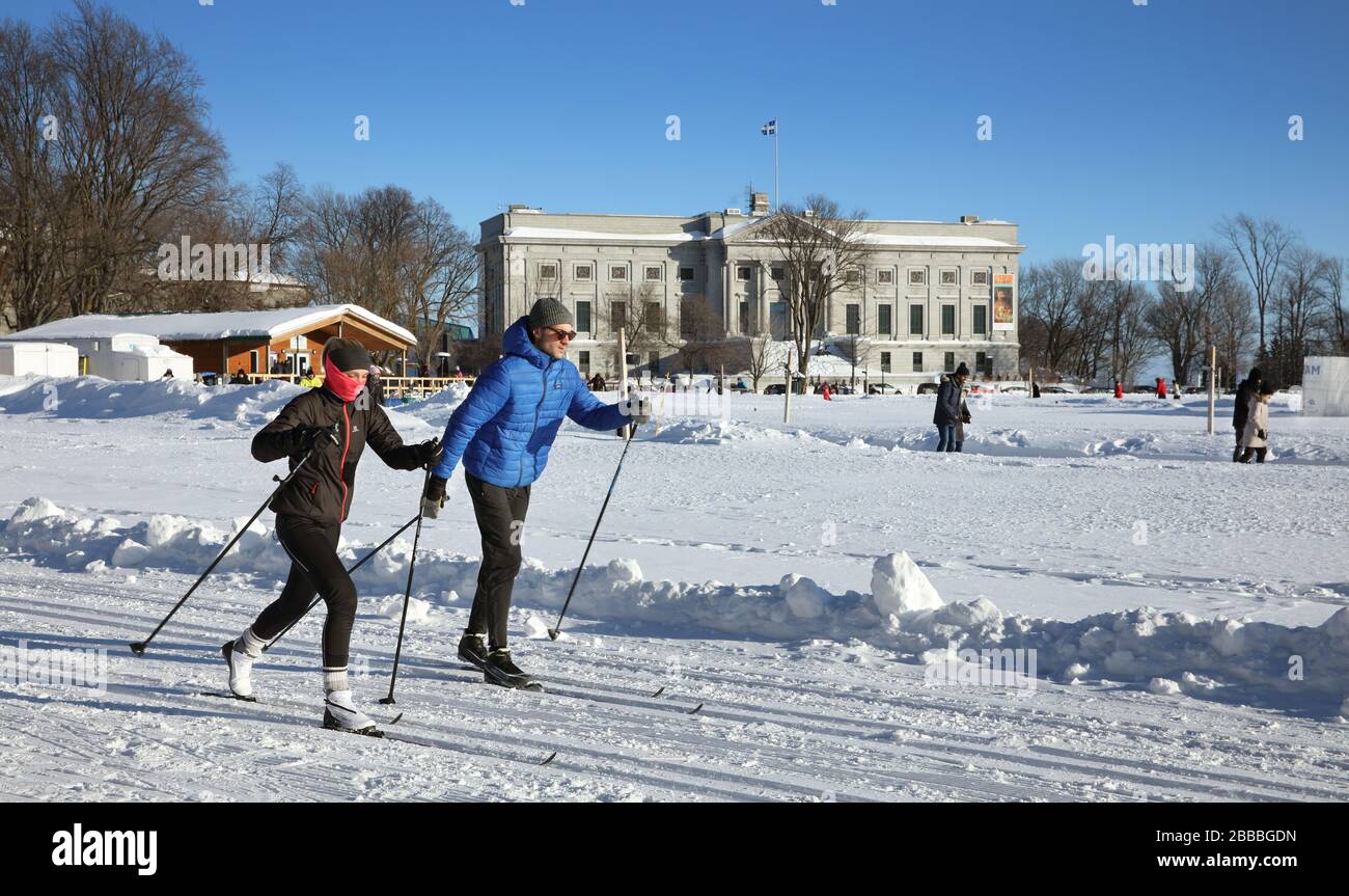 Cross-country skiers in the Plains of Abraham Battefields Park, Quebec City, Quebec, Canada. In the background is the main pavilion (Gerard-Morisset) of the Musee national des beaux-arts du Quebec. Stock Photo
