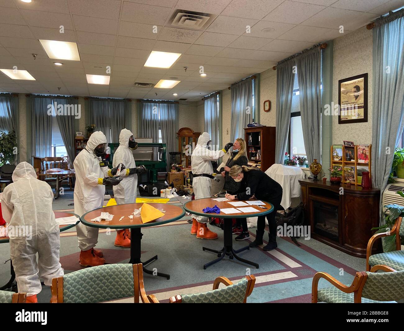 Members of the West Virginia National Guard's Chemical, Biological, Radiological, Nuclear and High Yield Explosive (CBRNE) Battalion and 35th Civil Support Team (CST) provide assistance for COVID-19 swabbing for the staff of a nursing facility March 23, 2020, in Morgantown, West Virginia. West Virginia CBRN experts have been providing assistance to the State of West Virginia in response to the current COVID-19 outbreak. (U.S. Army National Guard photo by Sgt. Davis Rohrer) Stock Photo