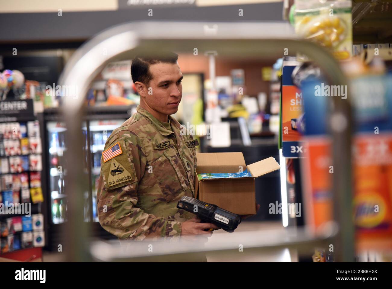 Sgt. Alejandro Sanchez, 158 Charlie Company infantryman, stocks shelves at a local grocery store in support of Pima County, Ariz., March 28, 2020. The Arizona National Guard activated more than 700 Arizona Citizen-Soldiers and Airmen to support grocery stores, food banks and other community needs during this state of emergency response (U.S. Air National Guard photo by Tech. Sgt. Michael Matkin). Stock Photo