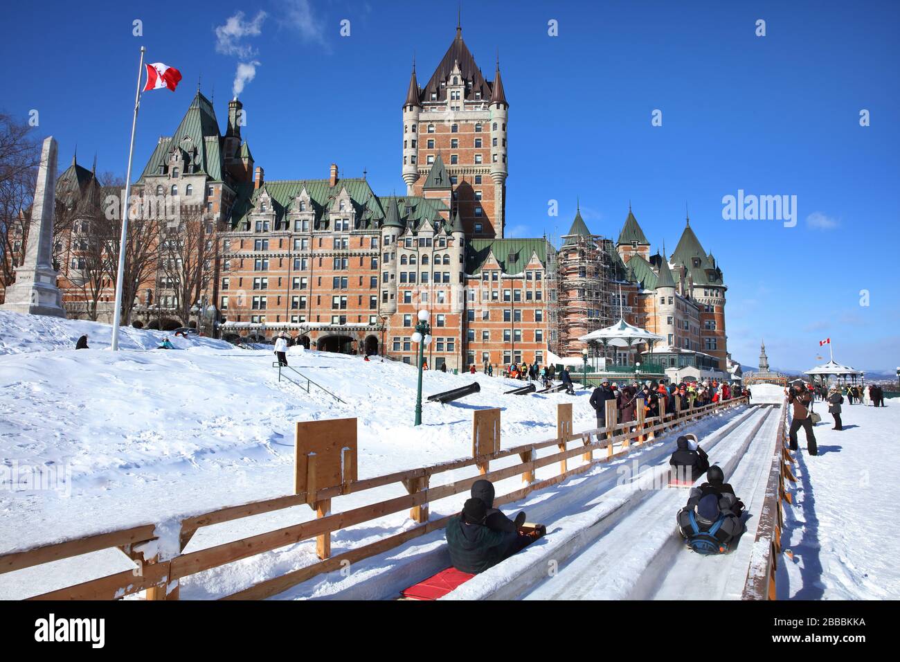 Riders on a toboggan slide that ends on Dufferin Terrace at the foot of Chateau Frontenac, Old Quebec City, Quebec, Canada Stock Photo