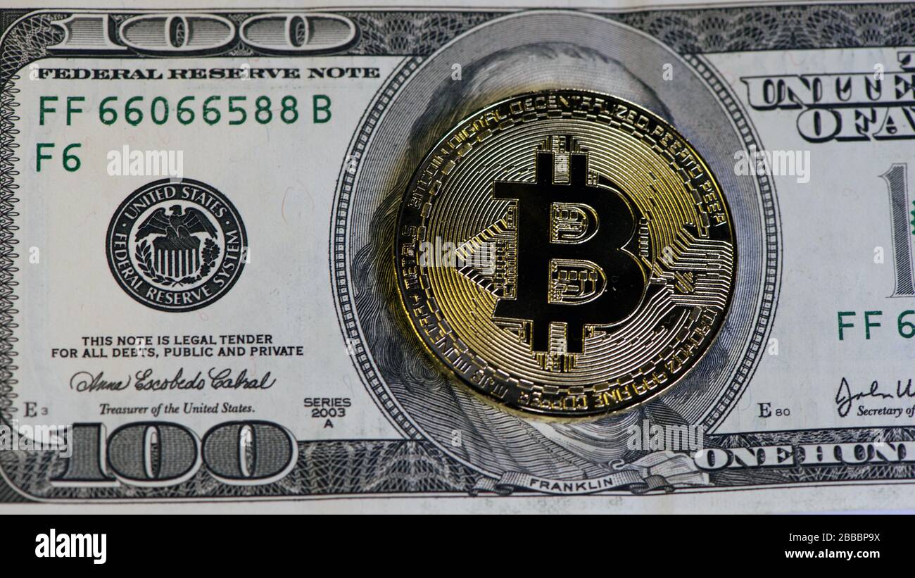 golden bitcoin coin on us dollars close up. Bitcoin mining: Miner figurine  digging ground to uncover big shiny bitcoin Stock Photo - Alamy