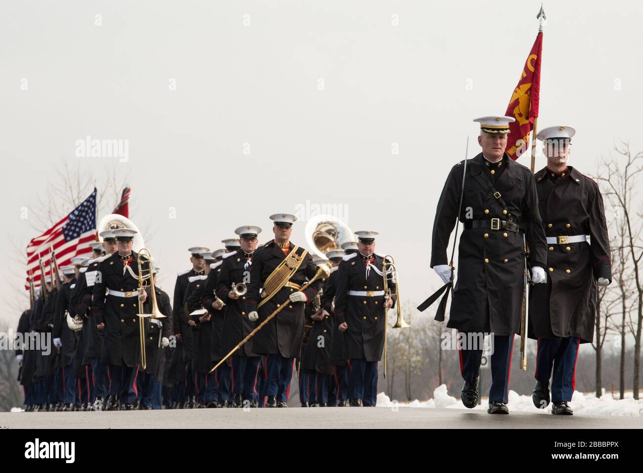 "Col. Christian G. Cabaniss, commanding officer of Marine Barracks Washington, D.C., The President's Own U.S. Marine Band and Barracks' ceremonial marchers march toward the gravesite of retired Col. Charles H. Waterhouse and his wife Barbara at Arlington National Cemetery, Feb. 19, 2014. Waterhouse and his wife were laid to rest 69 years to the day after he landed on Iwo Jima during World War II. Waterhouse originally left the Corps in 1946, but accepted a special commission as a major in the reserves in 1972 as the Marine Corps' first and only artist-in-residence. He painted more than 160 wor Stock Photo