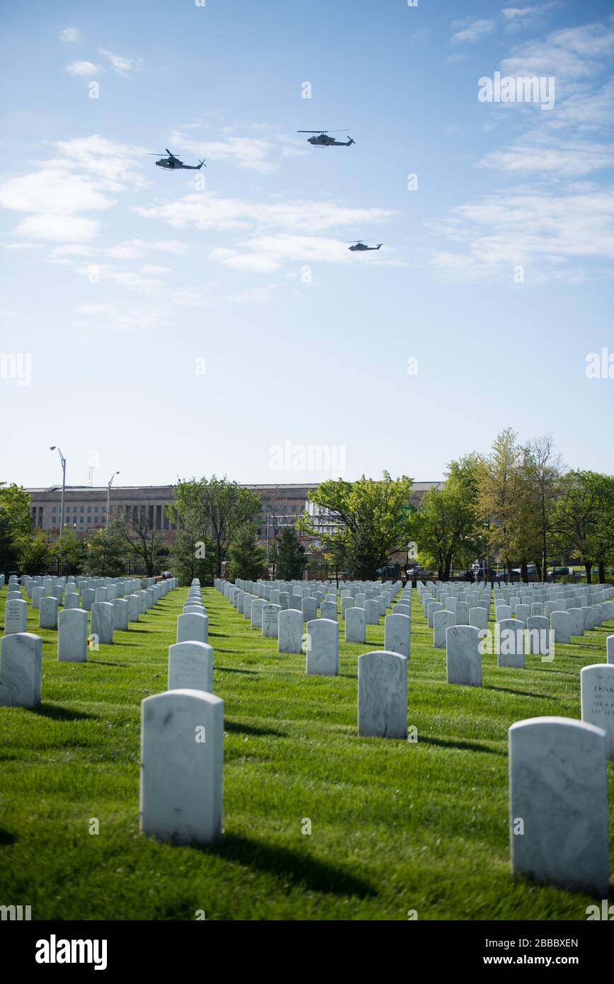 'AH-1W Super Cobras and UH-1Y Hueys fly over in the missing man formation during the graveside service for U.S. Marine Corps Maj. Elizabeth Kealey in Section 71 of Arlington National Cemetery, April 27, 2015, in Arlington, Va. Kealey died in a helicopter crash while conducting training at Marine Corps Air Ground Combat Center Twentynine Palms, Calif., Jan 23, according to a Marine Corps Air Station Miramar press release. (U.S. Army photo by Rachel Larue/released); 27 April 2015, 09:09; Missing man formation over Arlington National Cemetery; Arlington National Cemetery; ' Stock Photo