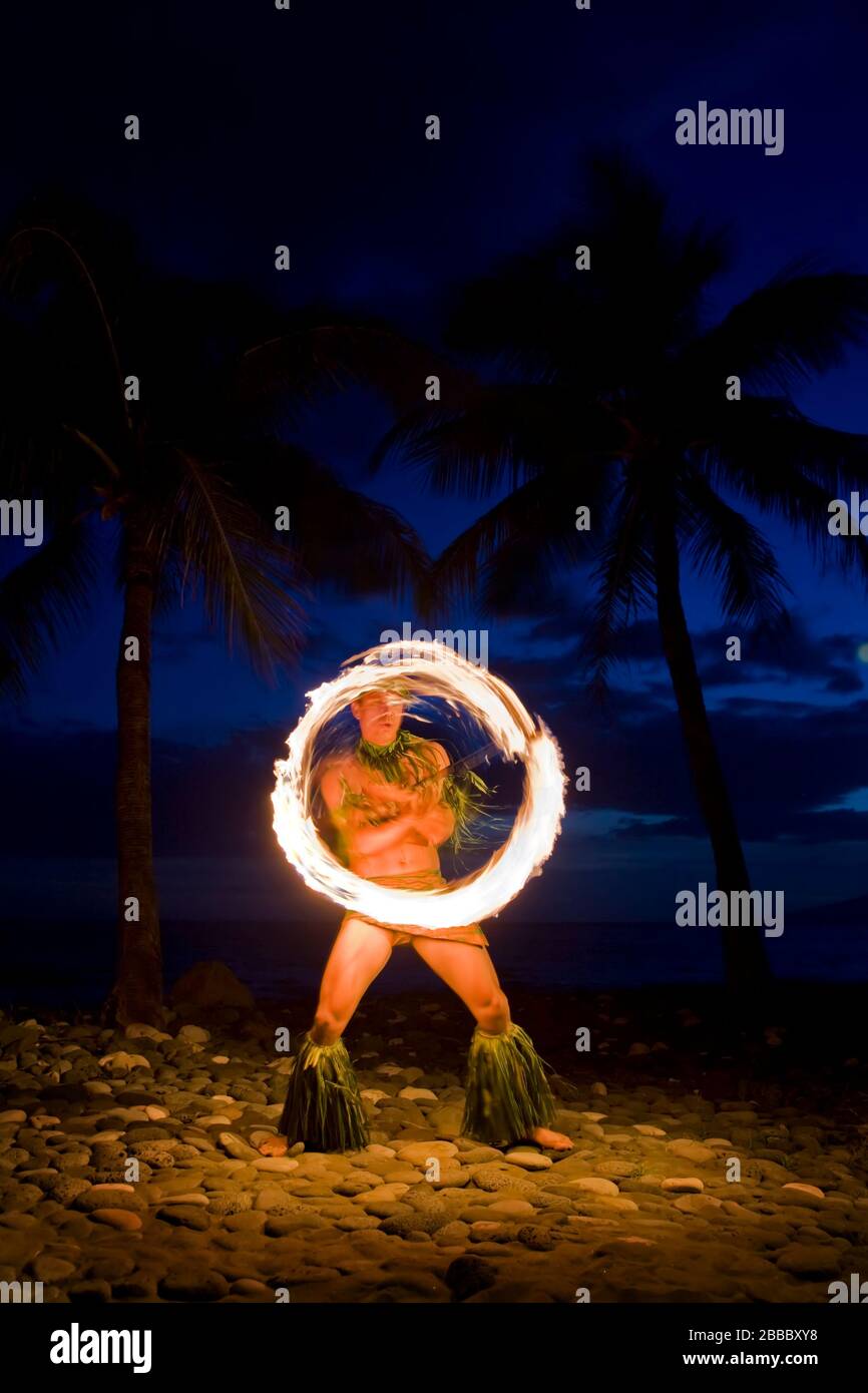 Fire knife dancer at night at Olowalu, Maui, Hawaii. Stock Photo