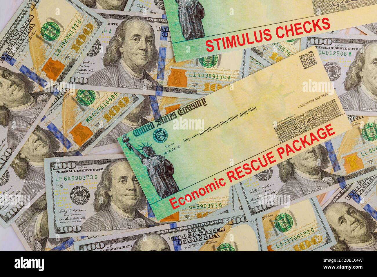 Economic Stimulus Bill Financial a stimulus bill individual checks from government US 100 dollar bills currency on American flag Global pandemic Covid 19 lockdown Stock Photo