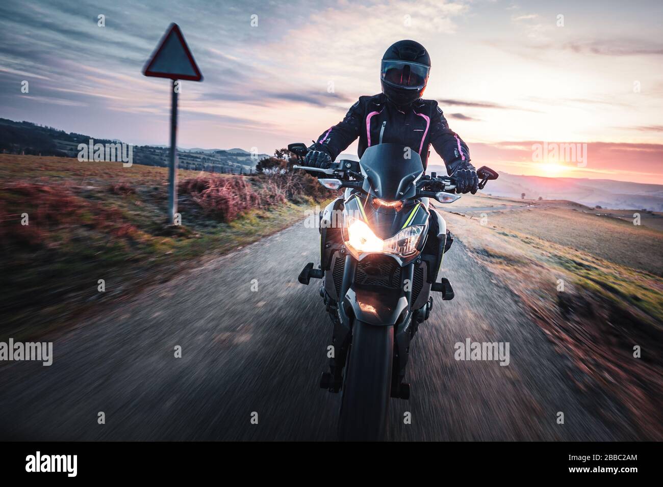 Motorcycle ride across scenic countryside at beautiful sunrise