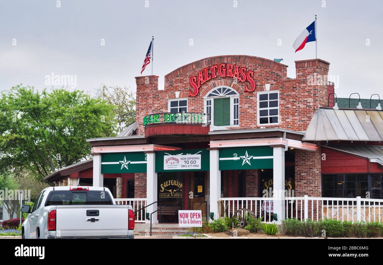 Saltgrass restaurant exterior in Houston, TX with a vehicle parked out front. Historic American restaurant serving steaks, chicken and seafood. Stock Photo