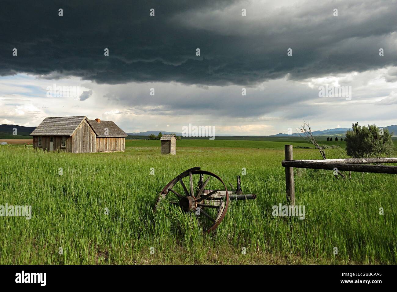 Farm house with storm clouds looming, Chesterfield, Idaho, USA Stock Photo