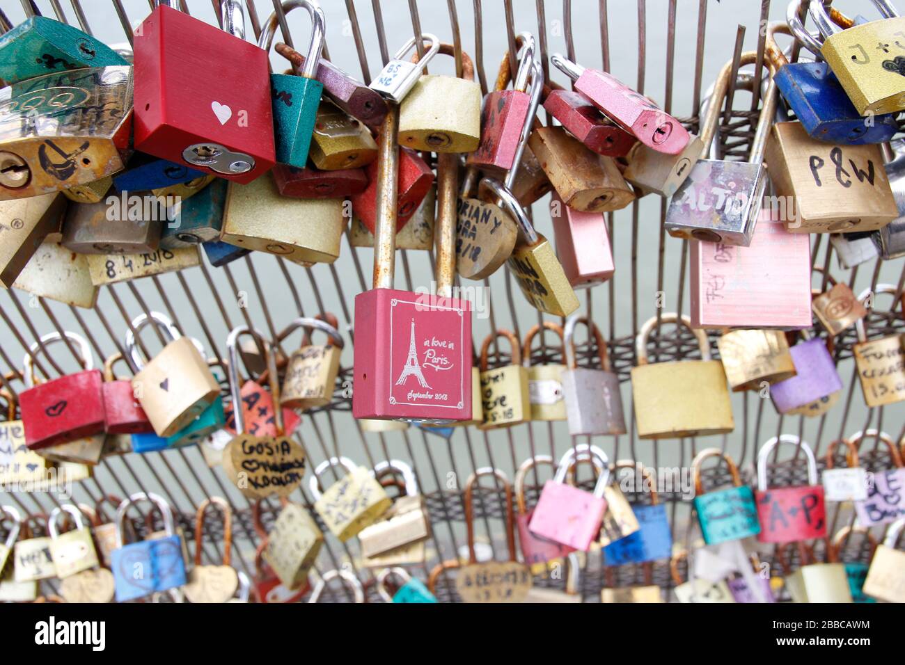 Colourful padlocks hanging on the fence of Passerelle Leopold Sedar
