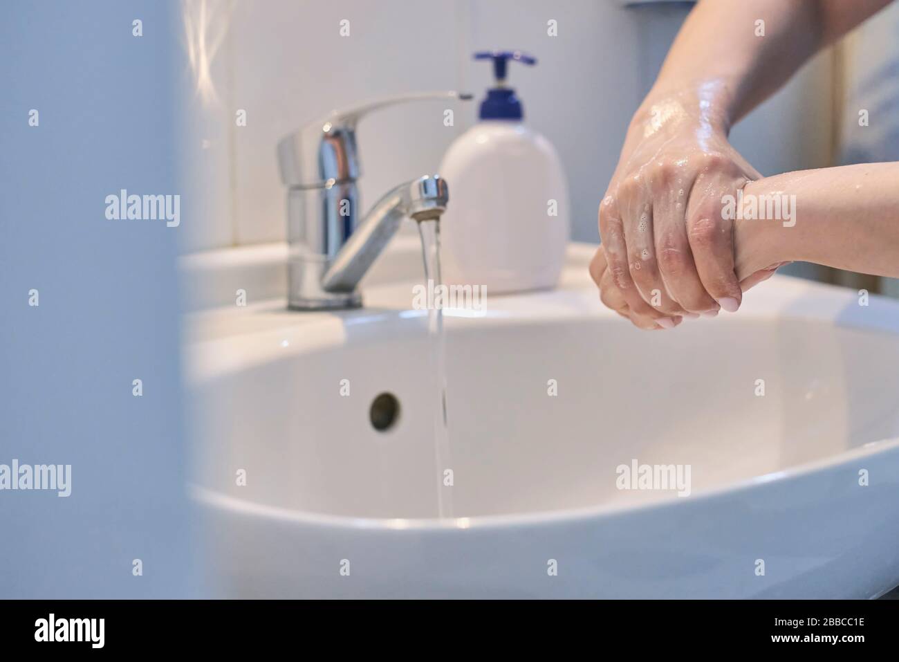 Unrecognizable female shows how to wash hands properly. Woman washs