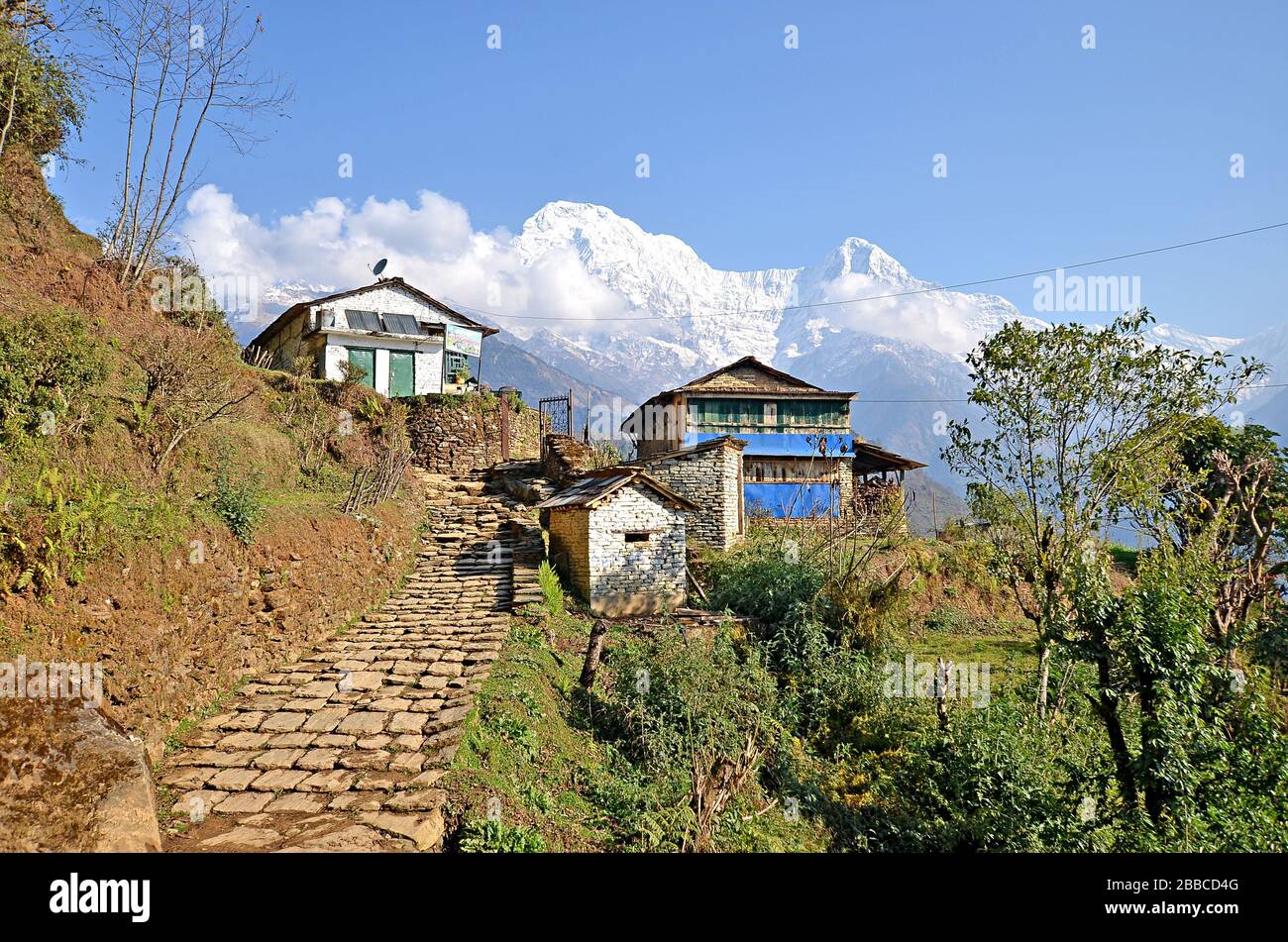 View at Ghandruk village, its buildings and grey roofs with Annapurna massif at the background with Fishtail mountain. The Himalayas mountains, Nepal. Stock Photo