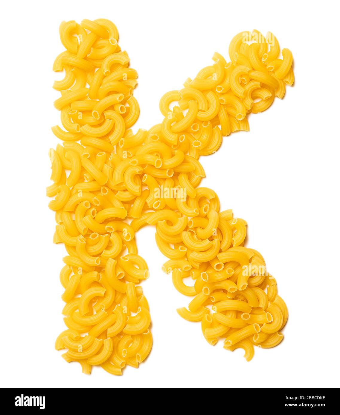 Letter K of the English alphabet from dry pasta on a white isolated  background. Food pattern made from macaroni. Bright alphabet for shops  Stock Photo - Alamy