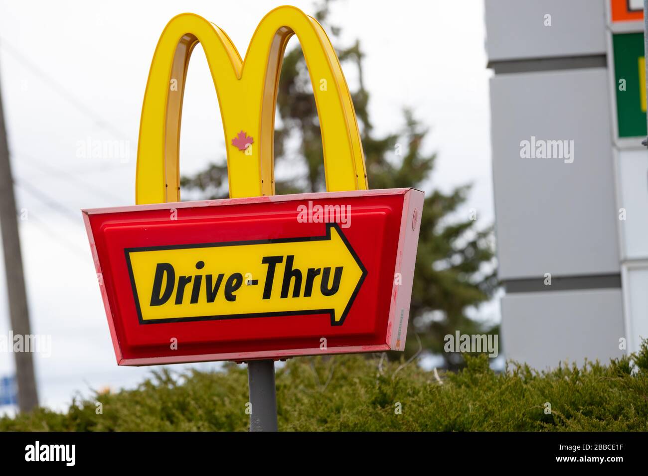 Close up of a sign showing McDonalds fast food restaurant drive thru ...