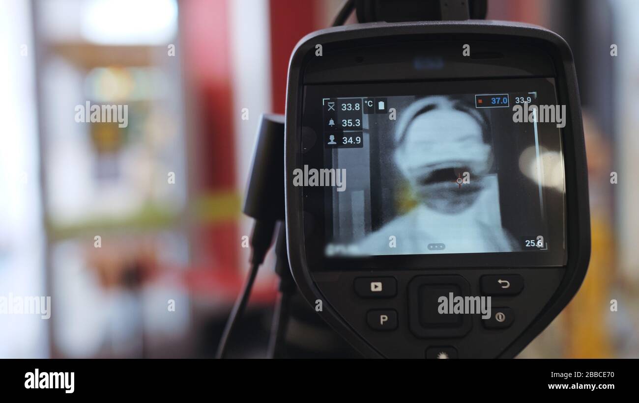 Temperature Check Commercial Temperature check at a supermarket, grocery store with a thermal ...