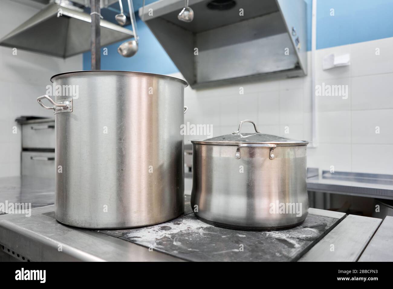 https://c8.alamy.com/comp/2BBCFN3/closeup-of-large-pots-on-the-stove-chef-cooking-at-commercial-kitchen-hot-job-real-dirty-restaurant-kitchen-2BBCFN3.jpg