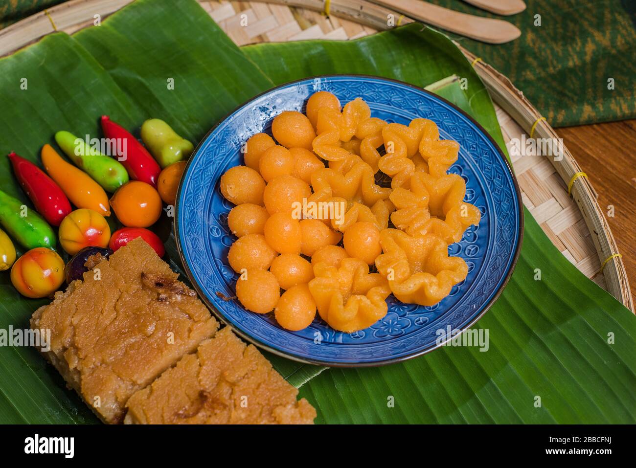 Thai desserts include Thongyib Thongyod, Kaeng Kaeng dessert, Chum balls placed on banana leaves. Stock Photo