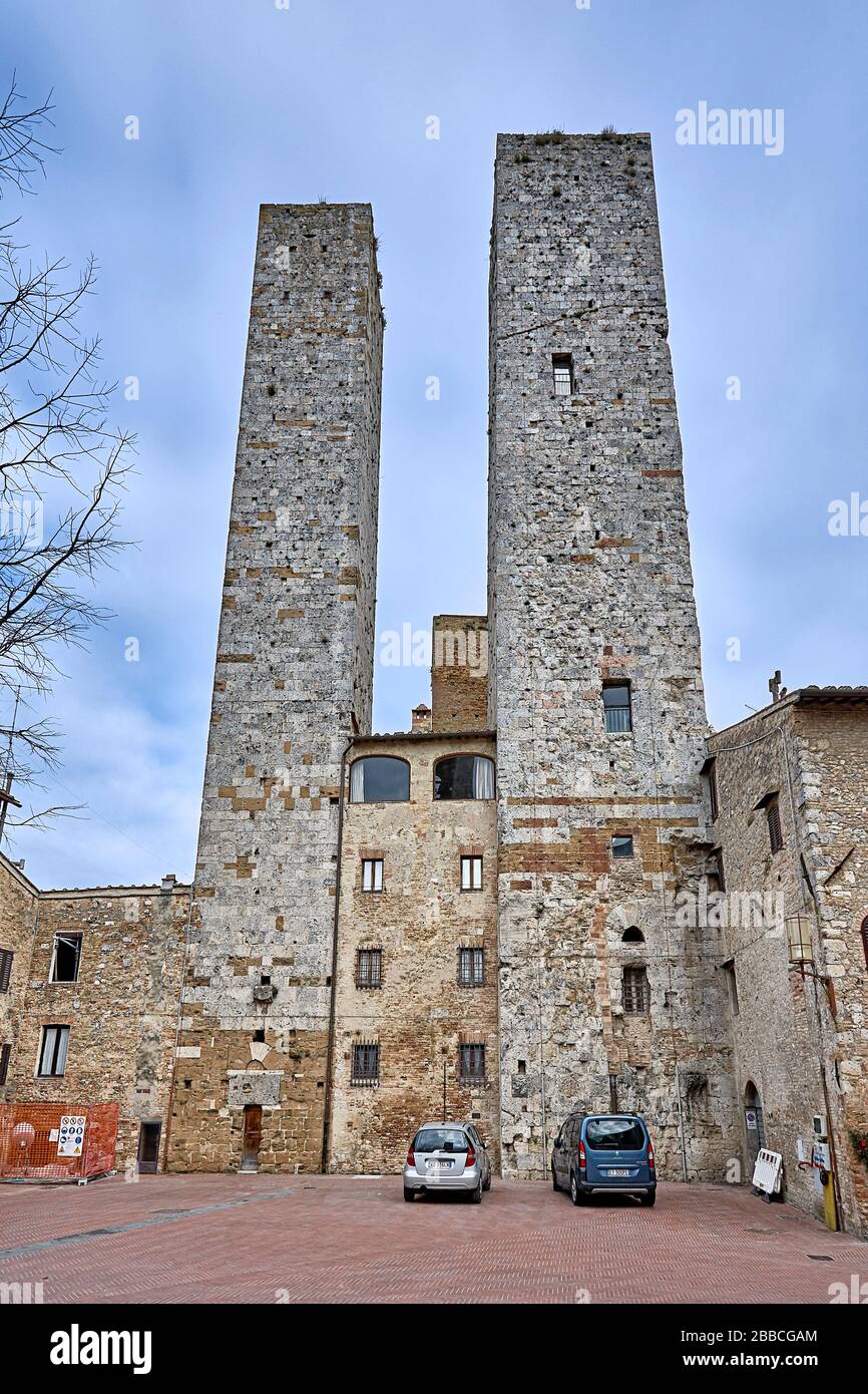 San Gimignano is an Italian hill town in Tuscany, southwest of Florence. Encircled by 13th-century walls, its old town centers on Piazza della Cistern Stock Photo