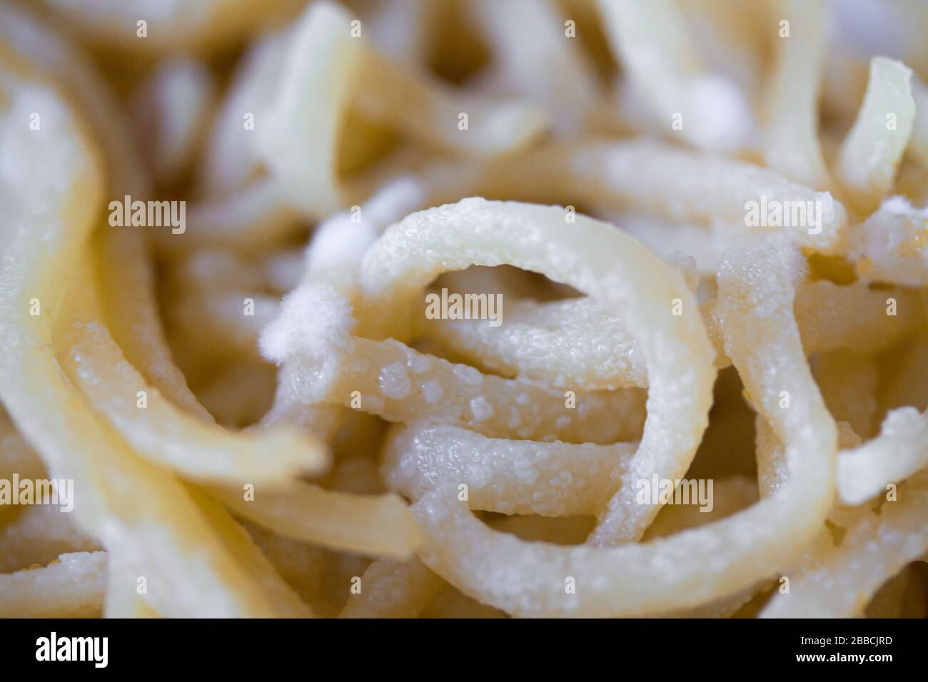 Spoiled spaghetti with mold. Pasta or noodles with white penicillum