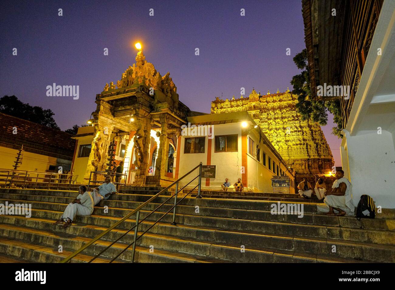 Thiruvananthapuram, India - March 2020: People sitting on the steps of the Shri Padmanbhaswamy temple on March 13, 2020 in Thiruvananthapuram, India. Stock Photo