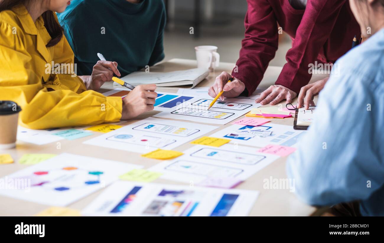 Close up ux developer and ui designer brainstorming about mobile app ...
