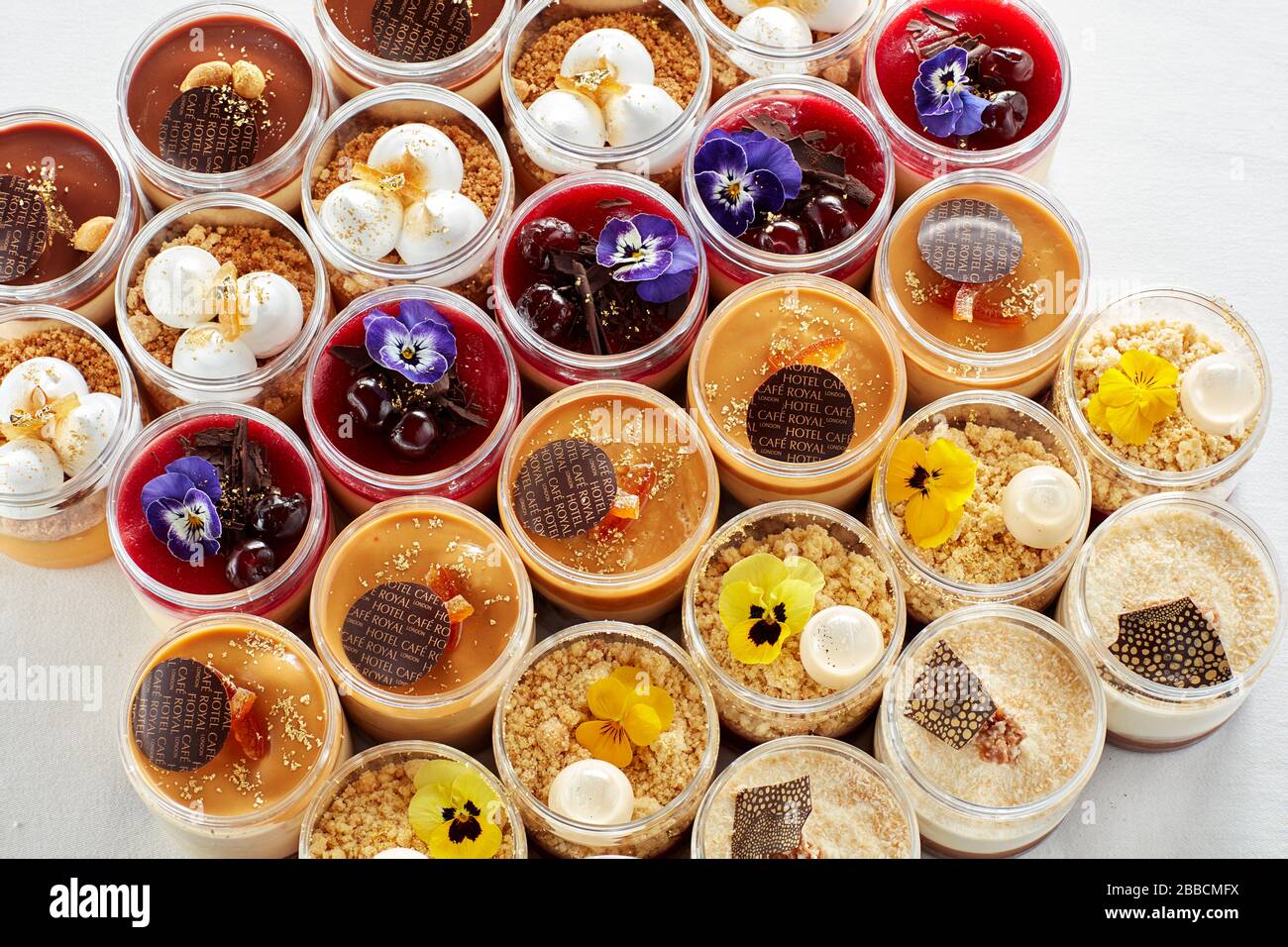selection desset pots colourful sweet pudding individual group lines display Stock Photo
