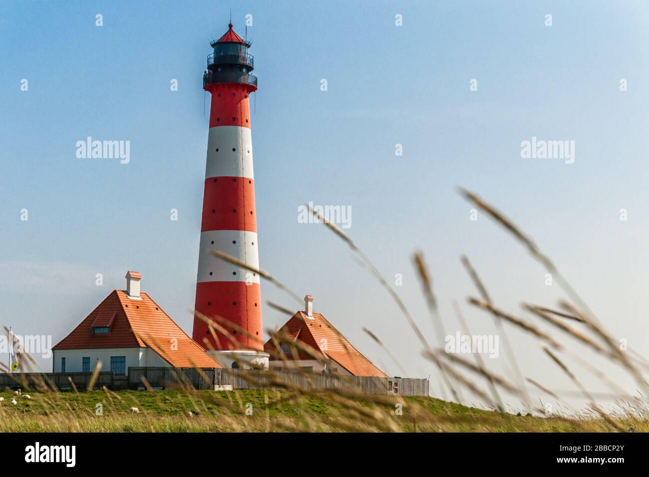 The Westerheversand lighthouse on the North Sea Stock Photo